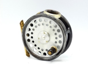 A good Hardy St George 3" trout fly reel, "spitfire" alloy drum with ebonite handle and three screw spring drum latch, ribbed brass foot, white gate line guide (no cracks), milled rim tension screw and Mk.I check mechanism, interior stamped "J.S." (Jimmy