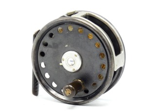 A rare Hardy Barton 3 &frac14;" trout dry fly reel, Shallow cored drum with reverse tapered ebonite handle and three screw spring drum latch, off-set ribbed brass foot, milled rim tension screw and Mk.II check mechanism, nickel silver rectangular four screw li