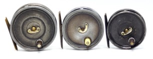 Three Hardy Uniqua trout fly reels; a 3 1/8" with ebonite handle, telephone drum latch, ribbed brass foot and fixed Mk.II check mechanism, a 2 7/8" with ivorine handle, brass foot, horseshoe latch and Mk.I check mechanism, and a 2 5/8" example, ebonite h