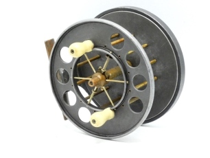 A fine and rare Allcock Aerial Mahseer 5 &frac14;" wide drummed centre pin reel, caged and six spoked alloy drum with twin bulbous xylonite handles, perforated front flange (eight holes), solid rear flange and twin release/regulator forks brass stancheon foot, r