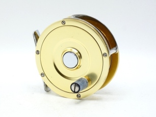 A scarce Fin-Nor Wedding Cake No.1 fly reel, right hand wind, gold anodised finish model with tapered composition handle, push button drum release, stainless steel block foot and triple cage pillars, rear stepped check housing with triform spindle mounted