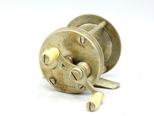 A scarce Horton Meek No.7 nickel silver multiplier bait casting reel, turned twin bone handles on off-set crank winding arm, bridge foot stamped " 9358", triple cage pillars, sliding optional check button to faceplate and milled, raised spindle caps, sta
