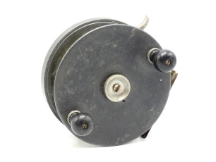 A Dingley(?) 6" alloy tunny/big game sea centre pin reel, solid drum (no perforations) with twin bulbous ebonised wooden handles and central milled tension nut, brass stancheon foot, rim mounted nickel silver brake lever and rear sliding optional check bu