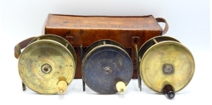 A 19th Century leather cased set of three W.B. Gowland & Co. brass plate wind 4" salmon fly reels, each with horn/bone handle, block foot, stamped fish logo, quadruple cage pillars, fixed check mechanism and script engraved makers Crooked Lane address de