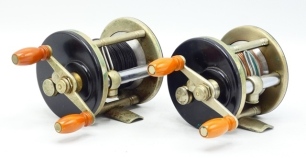 A J.A. Cox model 25 bait casting reel, ebonite and nickel silver construction, twin off-set ivorine handles on "S" scroll winding arm, turned triple drum pillars, bridge foot, sliding optional check button and milled tension regulator and a similar narro