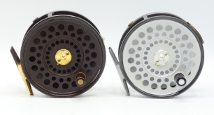 A Hardy St Aiden 3 &frac34;" sea-trout/trout fly reel, ltd. ed, First Edition model no. 010 with brown/gold anodised finish, ebonite handle, brass foot, two screw spring latch, adjustable dual check mechanism and a similar St Aiden standard model sea-trout/trou