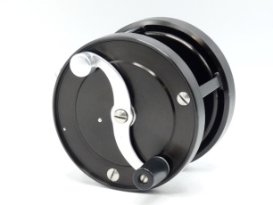 A superb S.E. Bogdan model 300 multiplying salmon fly reel and bespoke block leather case, black anodised finish right hand wind model with 2:1 ratio retrieve, counter-balanced serpentine crank winding arm set within an anti-foul rim, polished alloy foot,