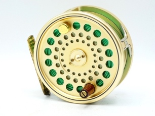 A Hardy Sovereign 9/10 salmon fly reel and spare spool, gold anodised finish, counter-balanced wooden handle, two screw spring latch, ribbed foot, rear sliding optional check button and spindle mounted milled tension adjuster, serial no. 253, light use o