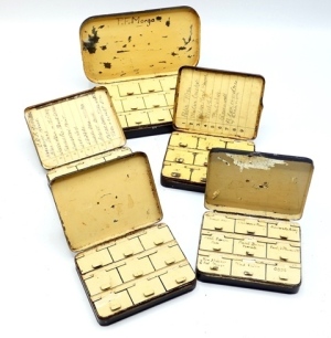 A Hardy Girodon Pralon japanned trout fly box, cream painted interior fitted fifteen lidded fly compartments and tweezer section (with tweezers), lid applied oval nickel silver trade plaque, and four Hardy waistcoat sized japanned dry fly boxes, fitted ni