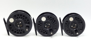 Three Hardy Sovereign 2000 trout fly reels, sizes #6, #5, #2/3/4, each with black anodised finish, counter-balanced composition handle, two screw drum latch and rear spindle mounted tension adjuster, new/unused condition in modern Selvyt bags and card bo