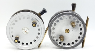 A Hardy Decantelle 4" bait casting reel, shallow cored drum with twin ebonite handles, brass foot, rim mounted ebonite casting trigger and milled brass tension screw, 1930's and a Hardy Silex 4" bait casting reel, twin ebonite handles, ribbed brass foot,