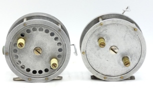A French Reflex 3 &frac34;" alloy tournament style bait casting reel, shallow cored drum with twin xylonite handles and domed steel locking nut, swing arm casting brake and two further rear casting controls and a similar Reflex No.2 3 &frac12;" model, both stamped make