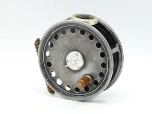 A Hardy St George 3 3/8" trout fly reel, shallow cored drum with ebonite handle and three screw spring latch, ribbed brass foot, white agate line guide (three very fine hairline cracks), milled rim tension screw and Mk.II check mechanism (lacking spare p