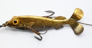 An exceptionally rare uncatalogued Gregory gilt metal 2 &frac34;" bait, the hollow gilt metal fish shaped lure with twin black spot/amber glass eyes, incised scale decoration and rear twin tail spinning vanes, one stamped makers name the other diamond registrati