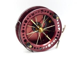 A fine Browning Revolver 4 3/8" centre pin reel, bronze anodised finish, shallow cored, six spoked drum with twin composition handles and twin release/regulator forks, pierced alloy foot, B.P. line guide, rear optional check lever and bar spring check mec