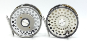 A Hardy Zenith Multiplier trout/sea-trout fly reel, composition handle on raised drive plate, alloy foot, two screw drum latch rim tension regulator, new/unused condition and a first model Hardy Zenith trout/sea-trout fly reel, twin pillar early version
