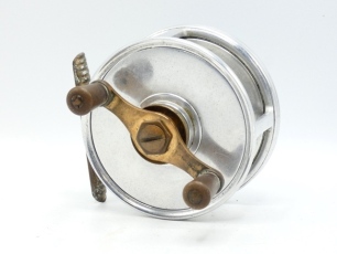 A rare Hardy Fortuna 4 &frac14;" big game sea centre pin/fly reel, twin reverse tapered ebonite handles on bronze cross-bar arm mounted above a knurled tension adjusting wheel, ribbed brass foot, solid drum (no perforations) with Andreas patent anti-reverse mec