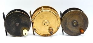 An Allcock's Thomas Patent 4 &frac14;" brass salmon fly reel, tapered horn handle, bridge foot, quadruple nickel silver drum pillars, raised rear check housing, lacking auxiliary brake mechanism, polished finish, a Holroyd brass 3 &frac34;" plate wind salmon fly reel,