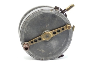 A rare Carter & Co. 7" alloy big game/tunny centre pin reel, bulbous ebonite handle on straight, counter-balanced crank winding arm, pierced six holes, rim mounted three point spring locking casting trigger with brass handle, further iron rim mounted bra