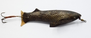 An unusual pressed tin 4" fish shaped lure, the hollow body with scale and fin decoration, twin spinning vanes, head swivel, leather tail and rear flying treble to short gimp trace, possibly by Allcock, circa 1890