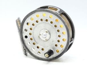 A scarce Hardy LRH Lightweight trout fly reel, early four pillar model with ebonite handle, ribbed alloy foot, three screw spring drum latch, milled rim tension screw and Mk.II check mechanism, nickel silver "L" shaped line guide, interior stamped "T.A."