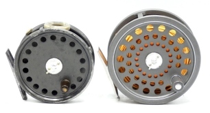 A Hardy J.L.H. Salmon fly reel, grey anodised finish, composition handle, two screw drum latch, alloy foot, rear spindle mounted tension adjuster, light use, in modern Selvyt bag and a Hardy St George 3 3/8" trout fly reel, ebonite handle, alloy foot, wh