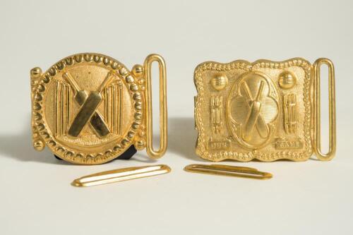Cricket belt buckles. A pair of belt buckles, both mint tradesman&rsquo;s samples, and unused, in soft gilt metal. The first, with legend &lsquo;Our Game&rsquo;, of rectangular form with crossed bats to centre, stumps and cricket balls to sides with beaded border, the othe