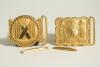 Cricket belt buckles. A pair of belt buckles, both mint tradesman&rsquo;s samples, and unused, in soft gilt metal. The first, with legend &lsquo;Our Game&rsquo;, of rectangular form with crossed bats to centre, stumps and cricket balls to sides with beaded border, the othe