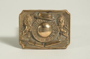 &lsquo;Honi soit qui mal y pense&rsquo; translates roughly to &lsquo;Shame on him who thinks evil of it&rsquo;. Brass cricket belt buckle of oblong form with large cricket ball to centre with the legend in circle around it, two lions to sides, boater to top and two bats below. 2