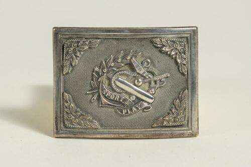 &lsquo;Sport & Play&rsquo;. Silver metal cricket belt buckle of oblong form with anchor, wreath, cricket bat and ball and the legend to centre, Floral corner borders . Approximately 2.75&rdquo;x2&rdquo;. Good condition