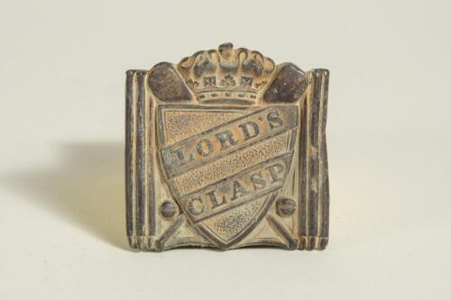 &lsquo;Lord&rsquo;s Clasp&rsquo;. Square early Victorian belt buckle with crossed bats, balls, stumps etc with shield to centre with raised inscription and crown to top. 2.25&rdquo;. Some wear, lacking bar and clasp to verso otherwise in generally good condition