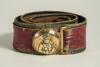 Cricket belt. Early and complete thick leather belt with circular brass belt buckle with figure of an early batsman wearing cap with bat over his shoulder and holding a cricket ball in his other hand. The buckle measures approximately 2&rdquo; diameter. The col