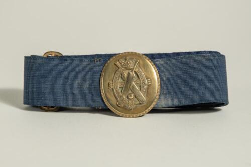 &lsquo;England&rsquo;s Delight&rsquo;. Early and complete material belt with oval shaped brass belt buckle showing crossed bats inter twinned in an oval circle with crown to top and horizontal cricket stumps with legend to oval circle. The buckle measures approximately 1.7