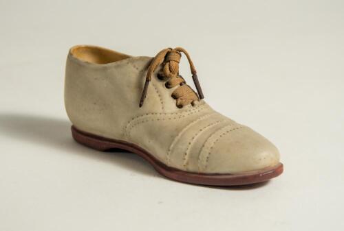 Victorian ceramic cricket shoe. A beautifully sculptured miniature ceramic cricket shoes, circa 1900 (or earlier), registration mark to heel of the shoe &lsquo;335843&rsquo;. The exquisite shoe, measuring 5&rdquo; long, in white canvas and leather uppers with red soles and