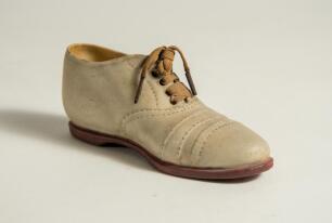Victorian ceramic cricket shoe. A beautifully sculptured miniature ceramic cricket shoes, circa 1900 (or earlier), registration mark to heel of the shoe &lsquo;335843&rsquo;. The exquisite shoe, measuring 5&rdquo; long, in white canvas and leather uppers with red soles and