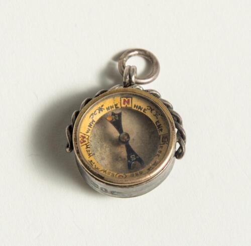 Cricketers&rsquo; compass. Small ornate Victorian silver hallmarked circular compass with compass to face and to verso image of batsman with stumps and wicket keeper behind. Metal loop suspension. Decorative casing. Unusual. Approximately .75&rdquo; diameter. Minor w