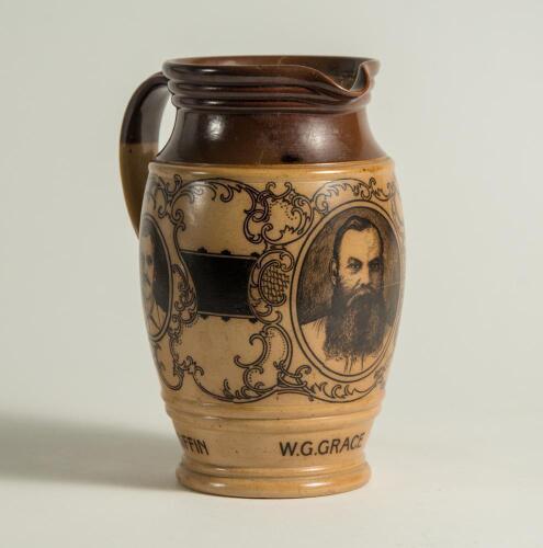 W.G. Grace. Impressive Doulton Lambeth stoneware jug with pale body and dark brown rim, decorated with three portraits/roundels of W.G. Grace, K.S. Ranjitsinhji and George Giffen within scrolling foliage. Two tone brown strap handle. Produced in 1896. App