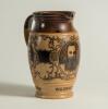W.G. Grace. Impressive Doulton Lambeth stoneware jug with pale body and dark brown rim, decorated with three portraits/roundels of W.G. Grace, K.S. Ranjitsinhji and George Giffen within scrolling foliage. Two tone brown strap handle. Produced in 1896. App