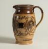 W.G. Grace. Impressive Doulton Lambeth stoneware jug with pale body and dark brown rim, decorated with three portraits/roundels of W.G. Grace, K.S. Ranjitsinhji and George Giffen within scrolling foliage. Two tone brown strap handle. Produced in 1896. App - 2