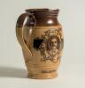 W.G. Grace. Impressive Doulton Lambeth stoneware jug with pale body and dark brown rim, decorated with three portraits/roundels of W.G. Grace, K.S. Ranjitsinhji and George Giffen within scrolling foliage. Two tone brown strap handle. Produced in 1896. App - 3