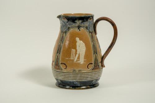 Doulton Lambeth stoneware jug, of bulbous form, moulded with relief vignettes of cricketers, a batsman, bowler and wicket keeper, Abel, Woods and McGregor in white on a brown background. With stylised floral leaf and flower Art Nouveau decoration to top a