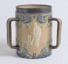 Doulton Lambeth stoneware tyg. Large, than normal, and impressive three handled tyg with three moulded relief vignettes of cricketers, a batsman, a fielder and wicket keeper in white on a brown background with stylised floral leaf and flower Art Nouveau d