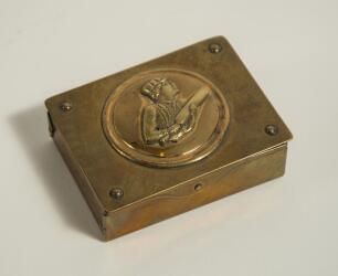 Brass cricket themed box. An attractive brass box with circular image of an early batsman wearing cap and holding his bat to lid. The interior of the box is compartmentalised. The box measures 3&rdquo;x2.5&rdquo;. Good condition