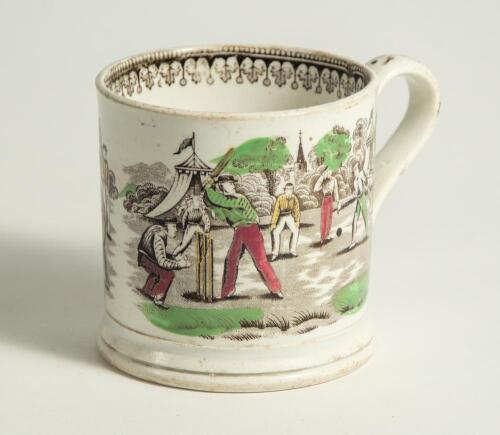 Village cricket mug. Staffordshire 19th century mug, transfer printed in black with two scenes of village cricket, with church and tents to background, floral and oak leaf inner rim decoration and crossed cricket bats, balls and stumps decoration to handl