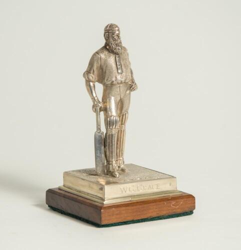W.G. Grace. Silver figure of W.G. Grace standing wearing cap and in batting pose with bat held to side. The figure mounted to wooden base with title to front &lsquo;W.G. Grace&rsquo;. Hallmarked London 2019 and the silver makers mark NVB for Norman Victor Bassant. Th