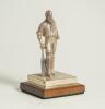 W.G. Grace. Silver figure of W.G. Grace standing wearing cap and in batting pose with bat held to side. The figure mounted to wooden base with title to front &lsquo;W.G. Grace&rsquo;. Hallmarked London 2019 and the silver makers mark NVB for Norman Victor Bassant. Th