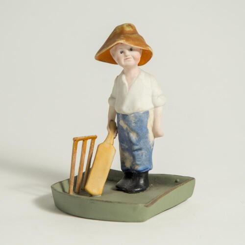 Kinsella. Ceramic ashtray with &lsquo;Kinsella&rsquo; boy batsman wearing floppy hat and holding bat, stumps to side, after Kinsella c1930&rsquo;s. Minor wear to figure otherwise in good condition