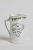&lsquo;The Boss&rsquo;. Royal Doulton Black Boy miniature flared lip jug, with printed image of a boy in red shirt and a floppy hat, wearing an umpire&rsquo;s coat with bat to side, title to side. To verso a crest with &lsquo;The All Black Team&rsquo;. Green floral decoration to outer - 2