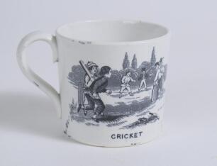 &lsquo;Cricket&rsquo; and &lsquo;Leap Frog&rsquo;. Victorian Staffordshire cricket mug with strap handle, transfer printed in black with images of an early cricket scene with boys playing cricket with title &lsquo;cricket&rsquo; below and to the other side a scene of boys playing Leap Frog 