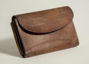 Ernest Robson. Somerset 1895-1923. &lsquo;Surrey v Somerset. The Oval 1900&rsquo;. Brown leather wallet with compartments for cash, coinage, documents, paper book for notes with bone? pen etc. Inscribed to the closing flap of the wallet Somerset v Surrey at The Oval